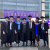 Leeds College of Building graduates stand in front of Leeds Beckett University for graduation