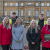 Six Blenheim Palace apprentices stand in front of the Blenheim Palace building. Four are women wearing winter coats. Two men stand at the back in high-vis jackets.