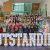 Large group gathered on staircase behind illuminated OUTSTANDING letters inside university building atrium.
